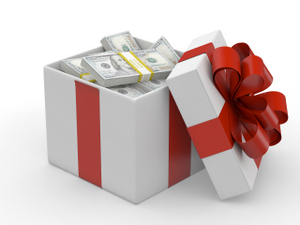 A gift box tied with a red ribbon, filled with dollar bills, symbolizing a monetary gift for a special occasion.  