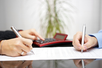Buyer and seller signing closing documents