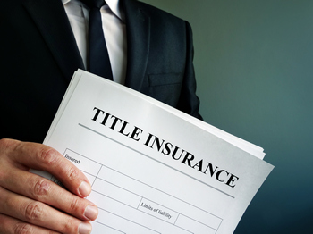 Title insurance document for homeownership, ensuring protection against property title issues and claims.